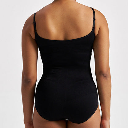Woman wearing a black bodysuit against a white background